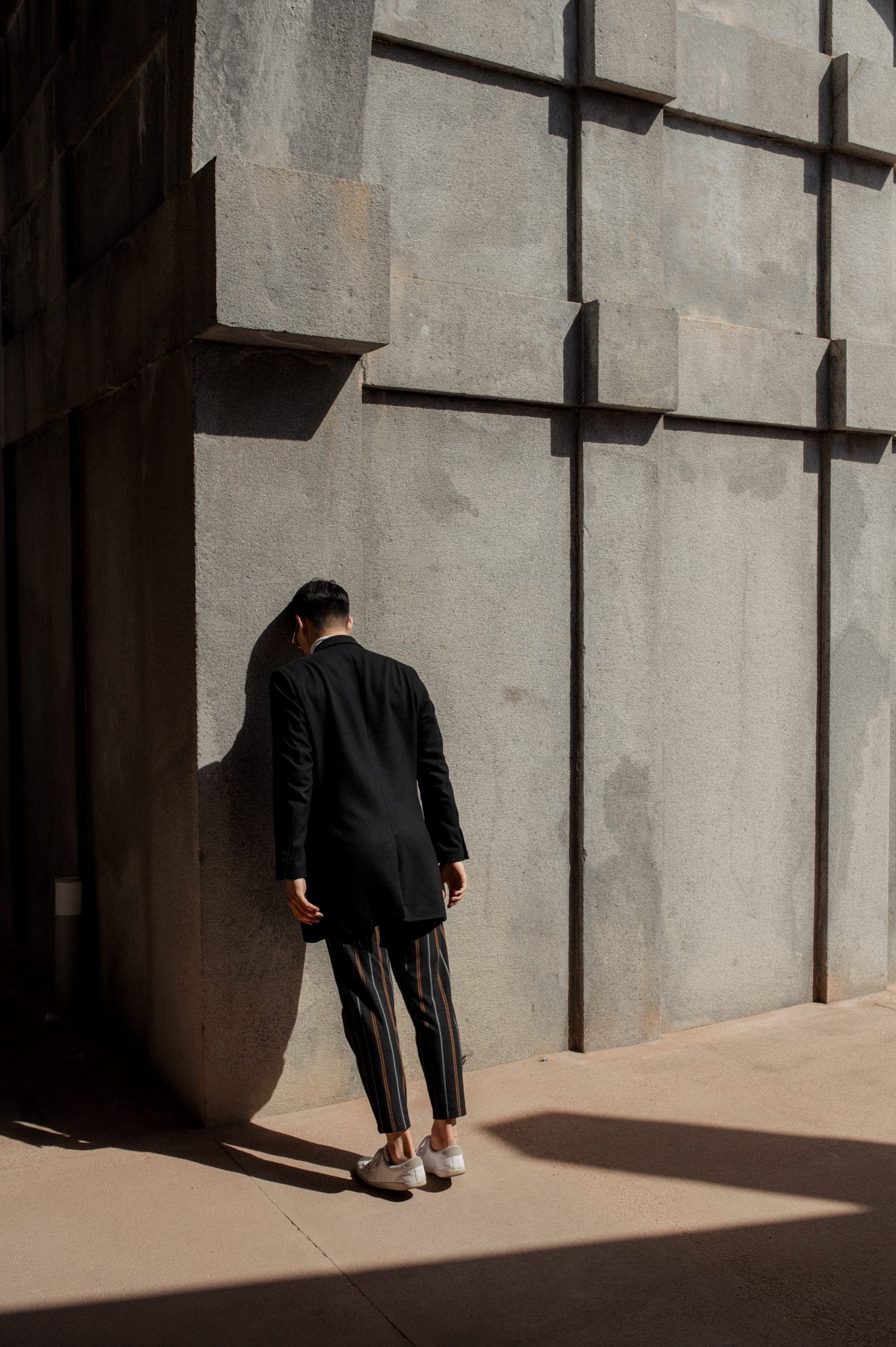 man leaning against the wall