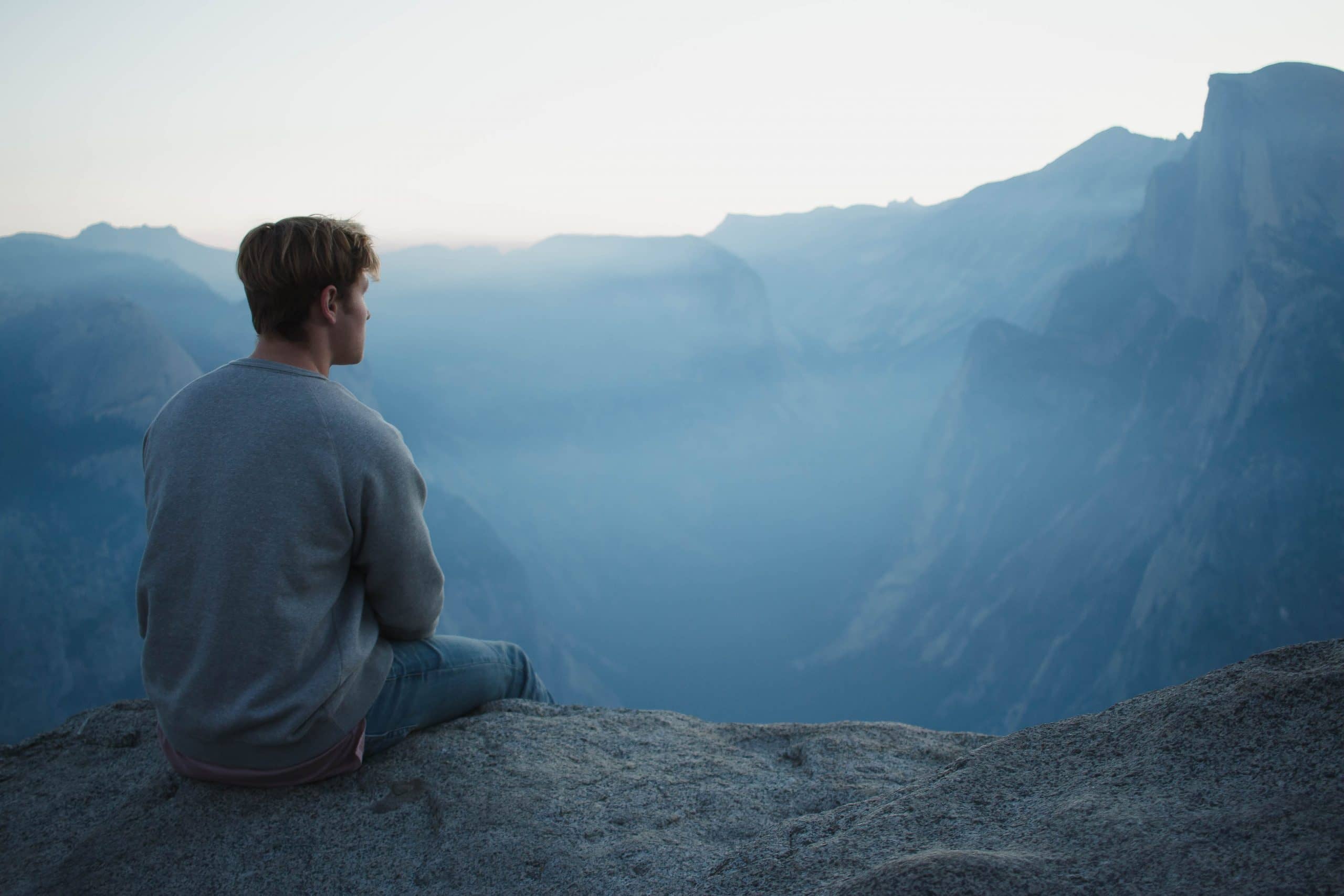 man looking into distance on mountain