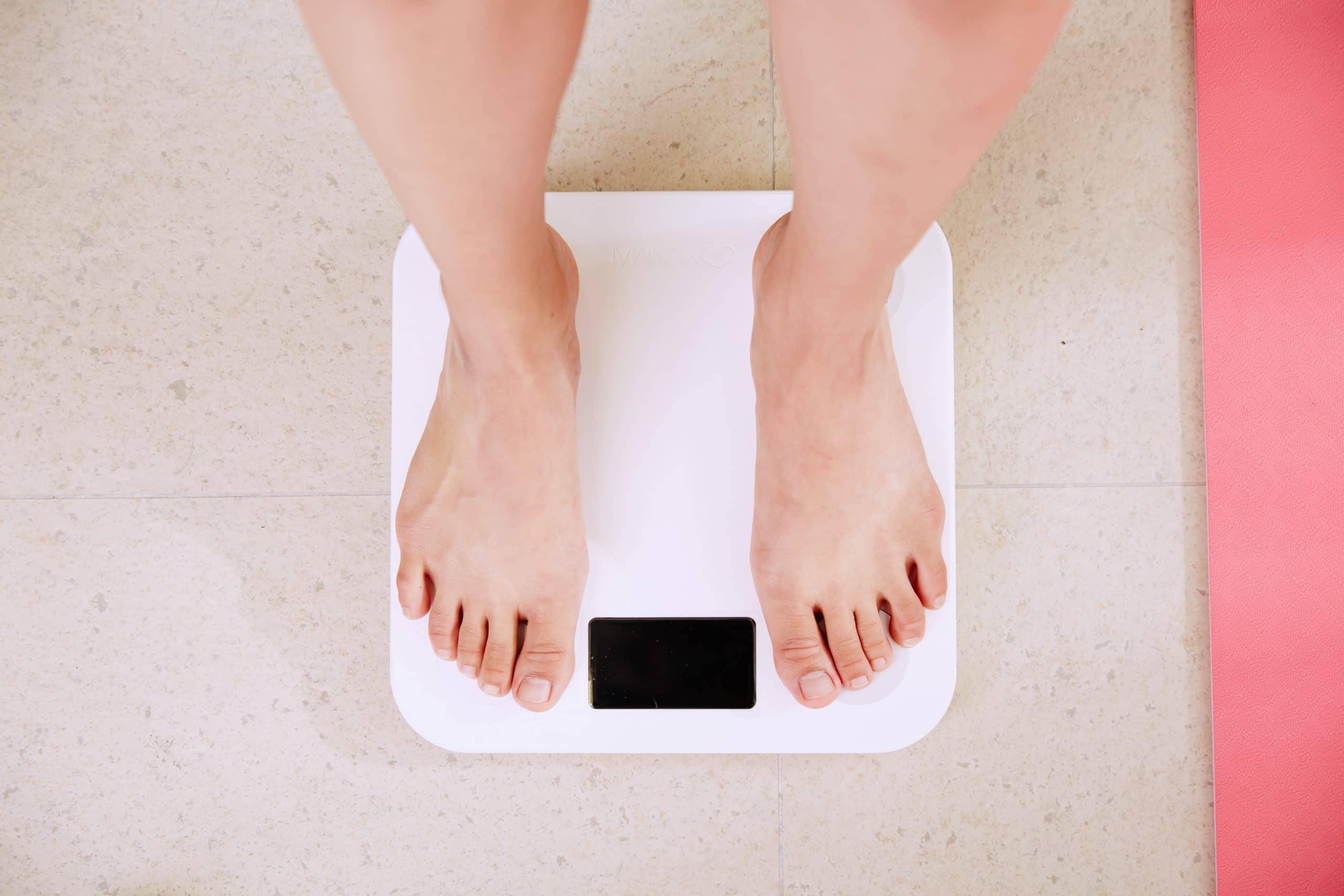 person the scales weighing themselves