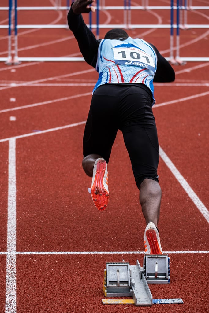 athlete leaving starting blocks