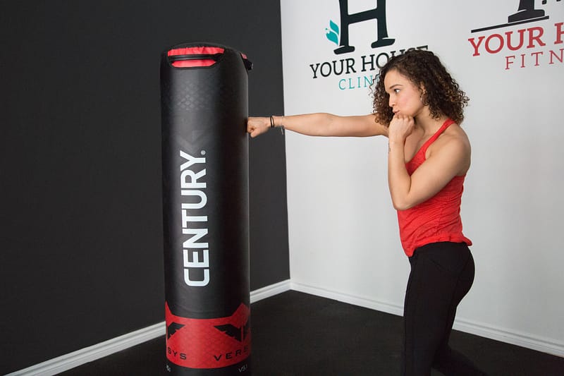 woman hitting punchbag